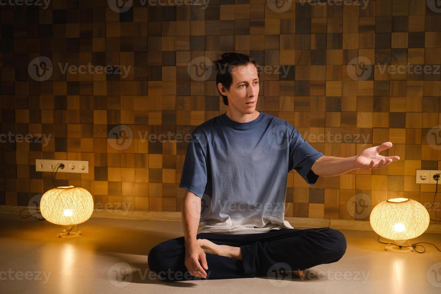 a man in a sports uniform does yoga in a fitness room. the concept of a healthy lifestyle photo