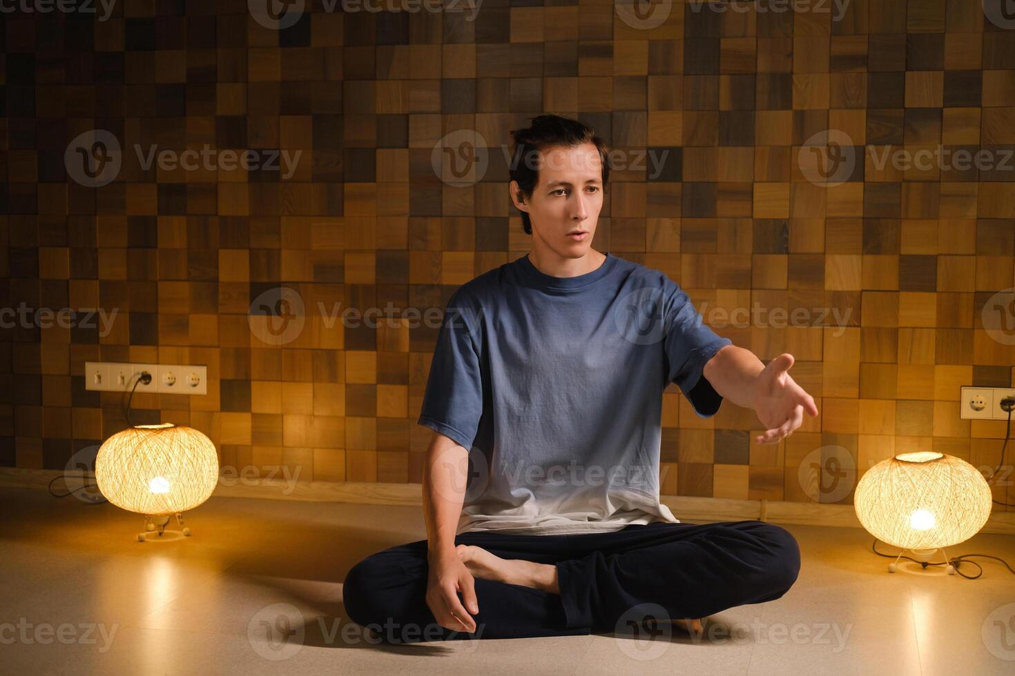 a man in a sports uniform does yoga in a fitness room. the concept of a healthy lifestyle photo