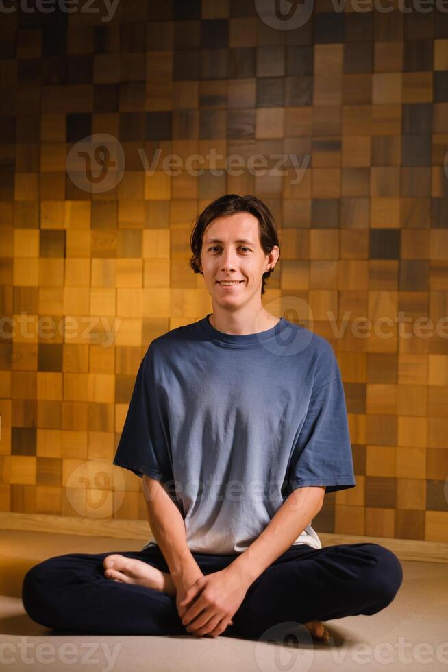 a man in a sports uniform does yoga in a fitness room. the concept of a healthy lifestyle photo