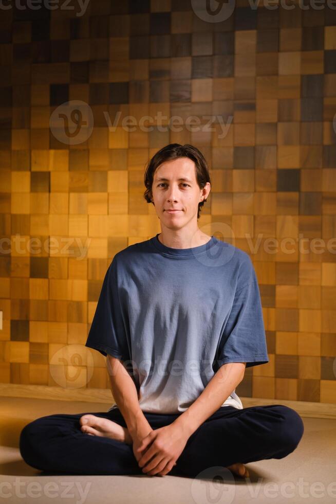 a man in a sports uniform does yoga in a fitness room. the concept of a healthy lifestyle photo