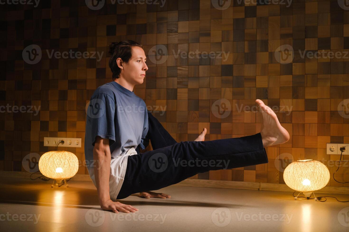 a man with a naked torso does yoga in the gym. the concept of a healthy lifestyle photo