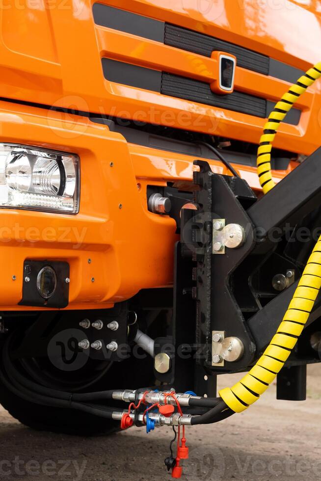 Close-up of the cab of an orange-colored truck photo