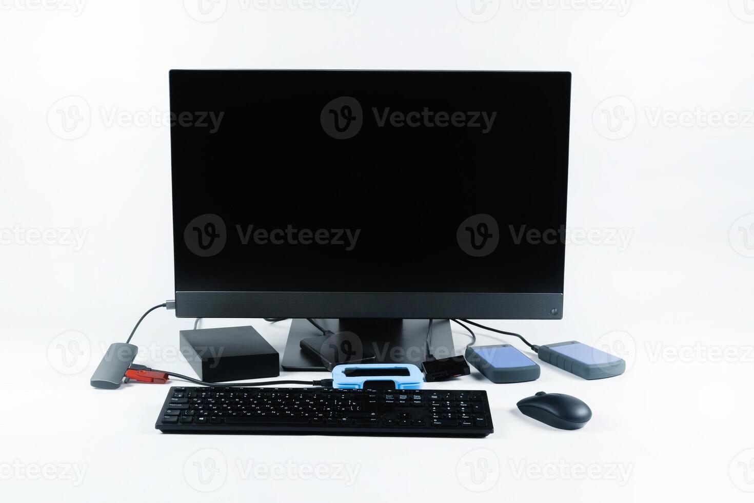 Multiple external hard drives connected to a monoblock on a white background.Computer with hard drive photo