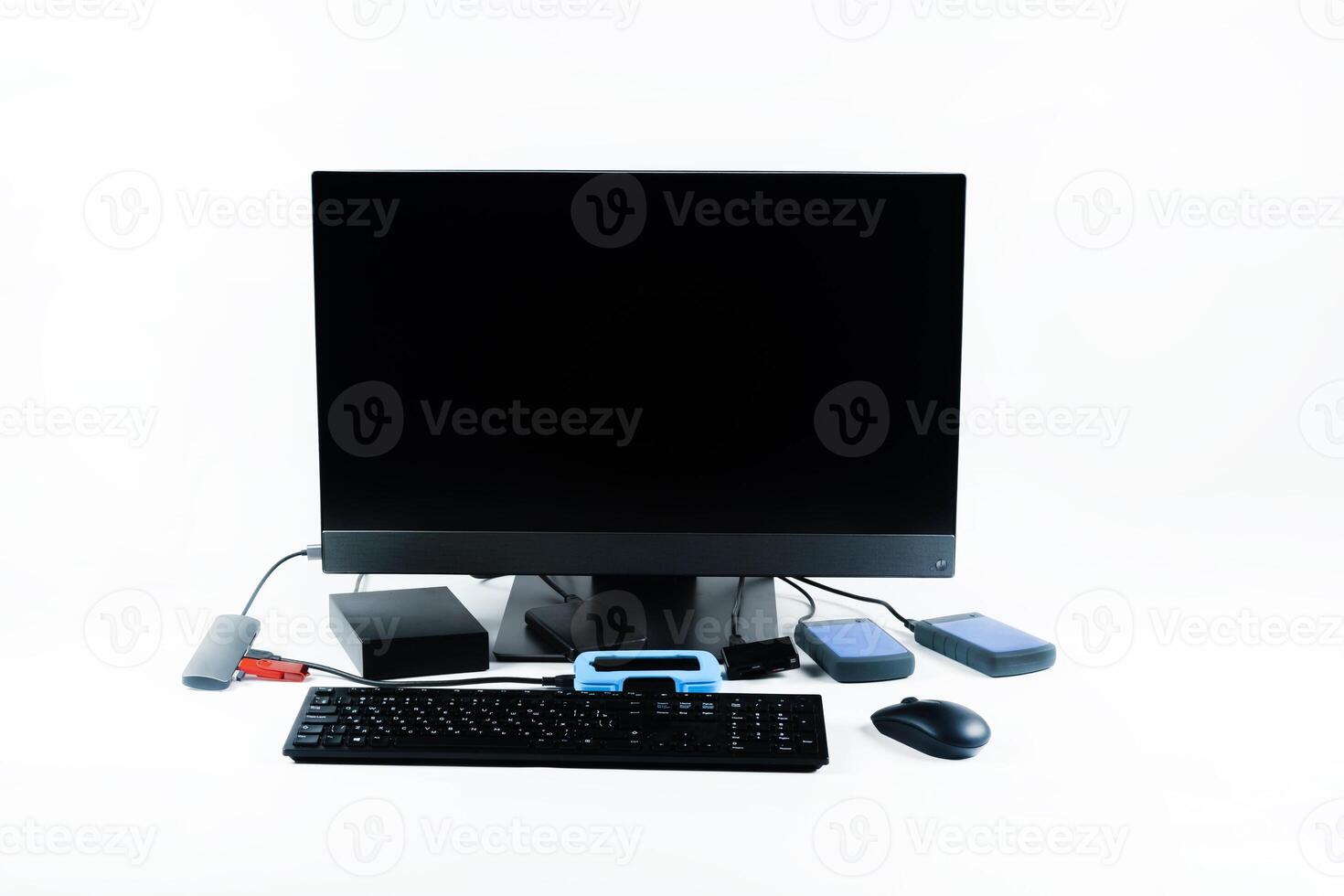 Multiple external hard drives connected to a monoblock on a white background.Computer with hard drive photo