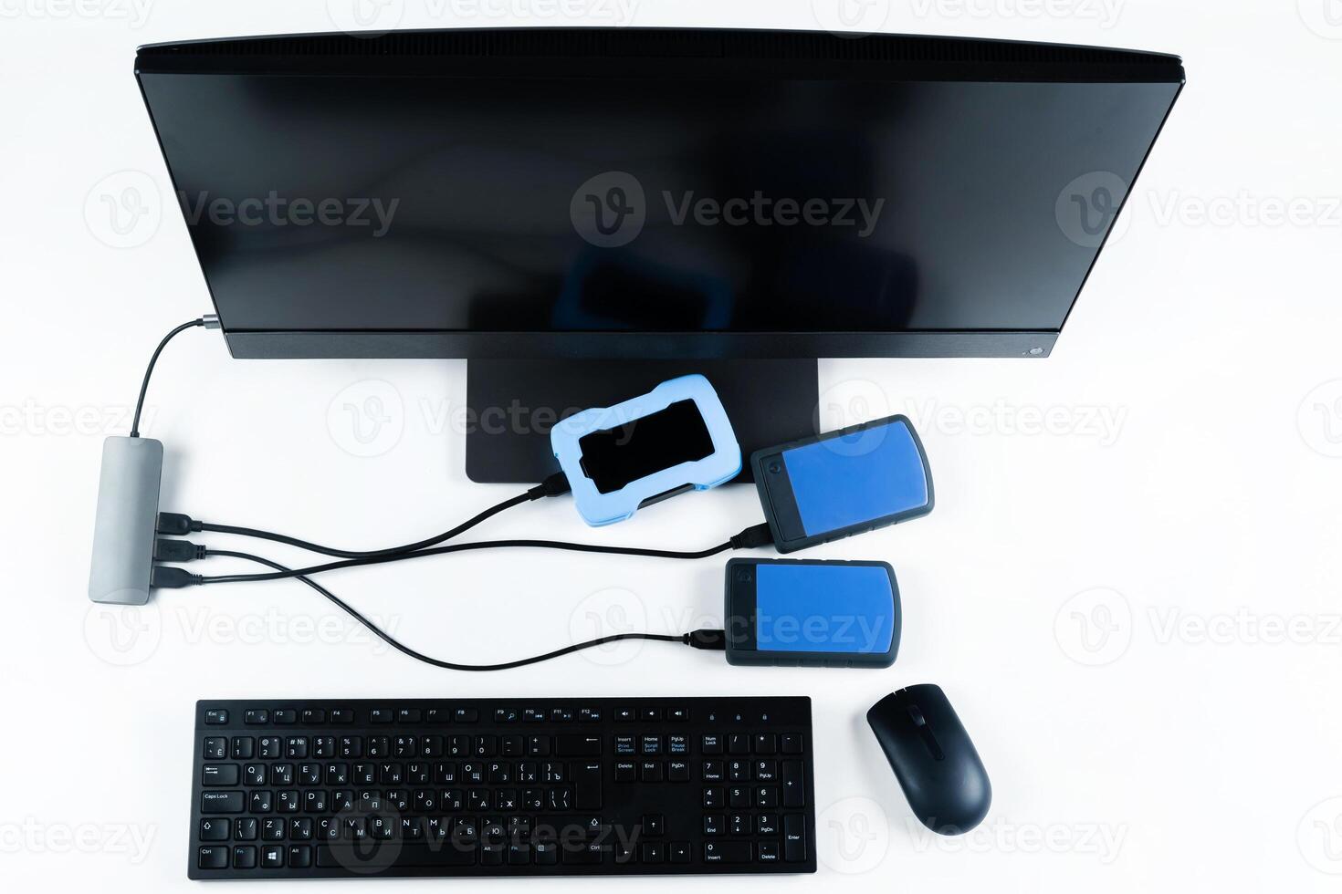 Multiple external hard drives connected to a monoblock on a white background.Computer with hard drive photo