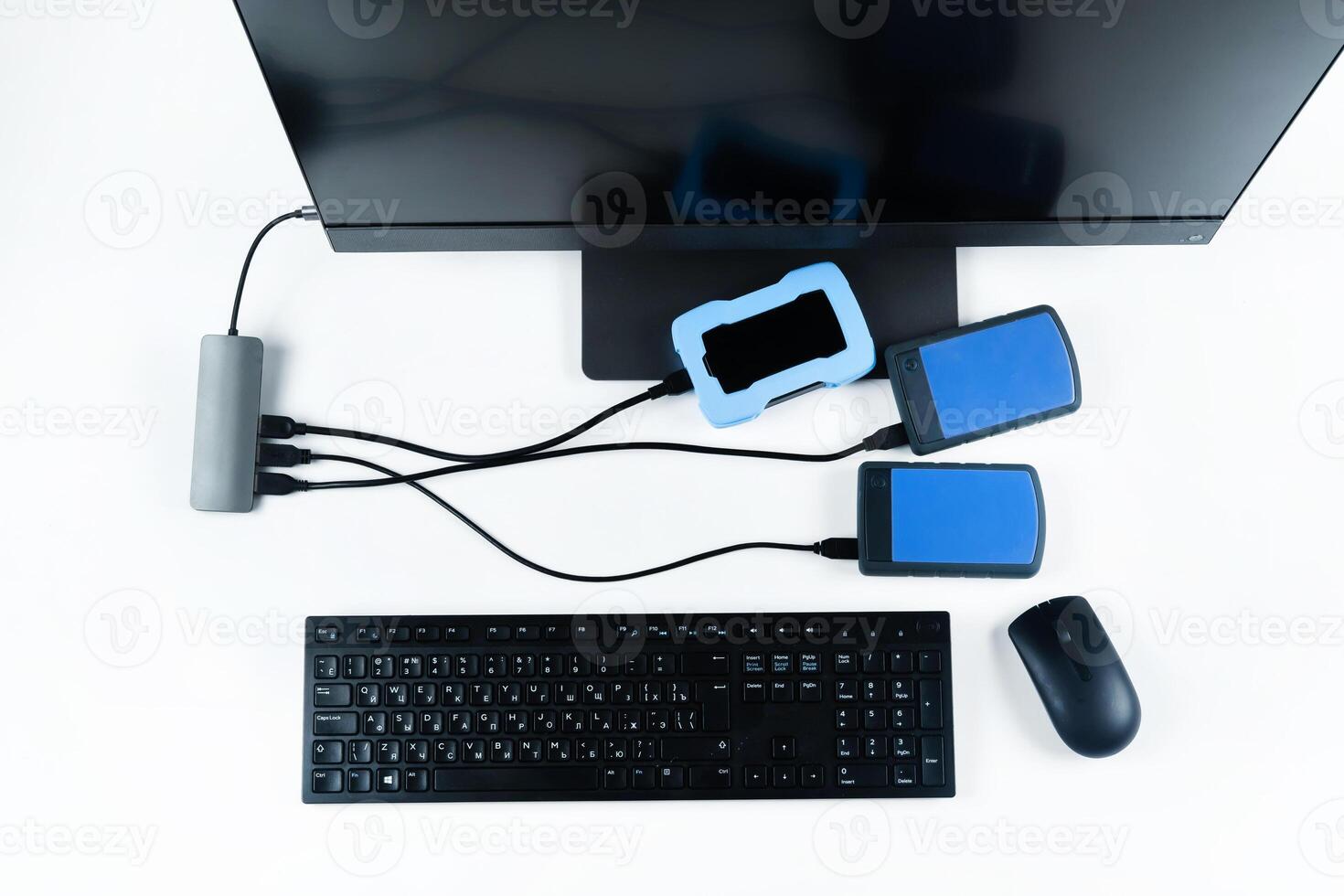 Multiple external hard drives connected to a monoblock on a white background.Computer with hard drive photo