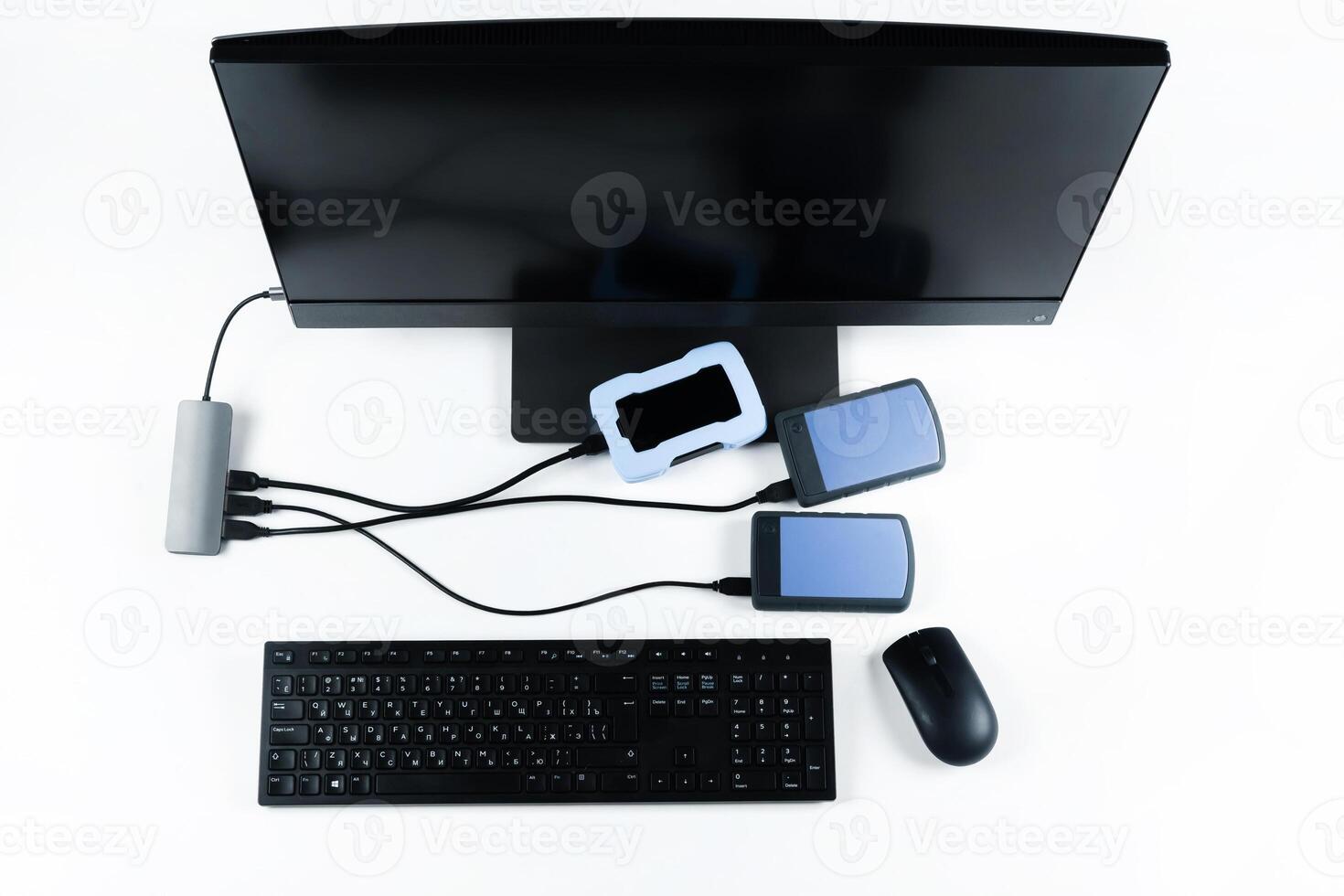 Multiple external hard drives connected to a monoblock on a white background.Computer with hard drive photo