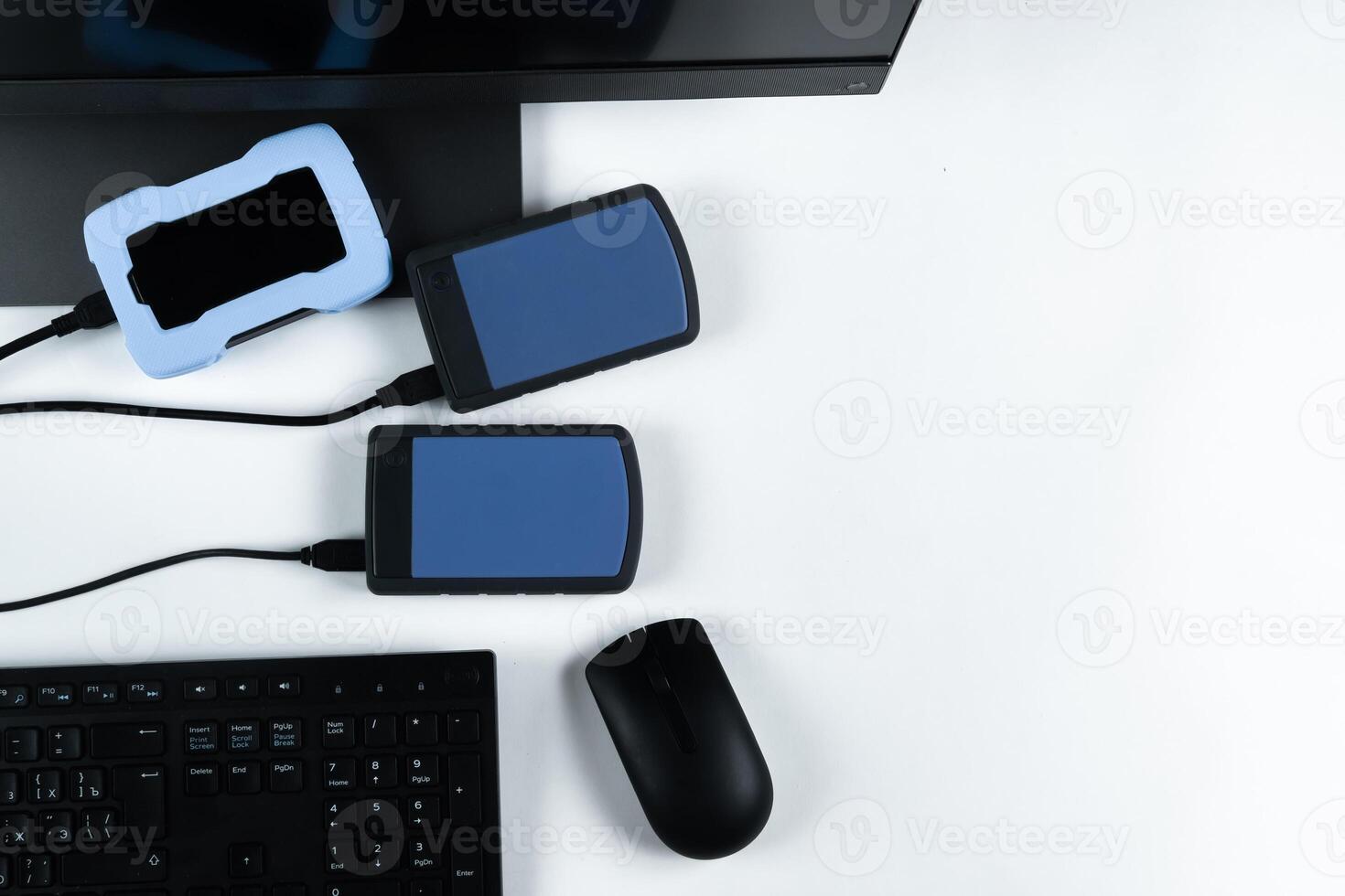 Multiple external hard drives connected to a monoblock on a white background.Computer with hard drive photo