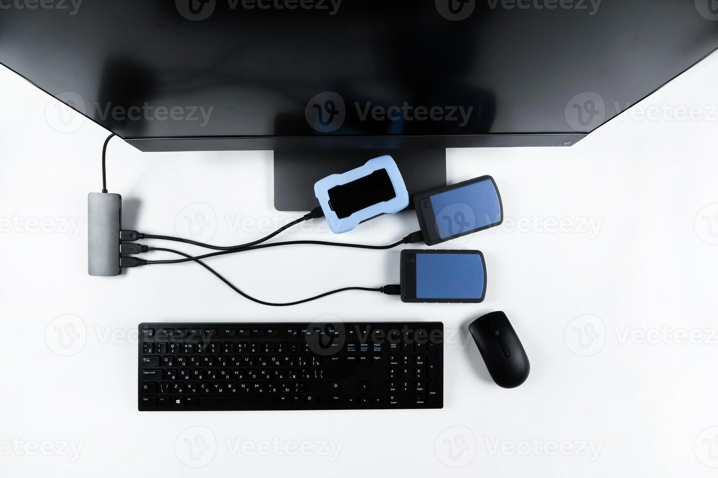 Multiple external hard drives connected to a monoblock on a white background.Computer with hard drive photo