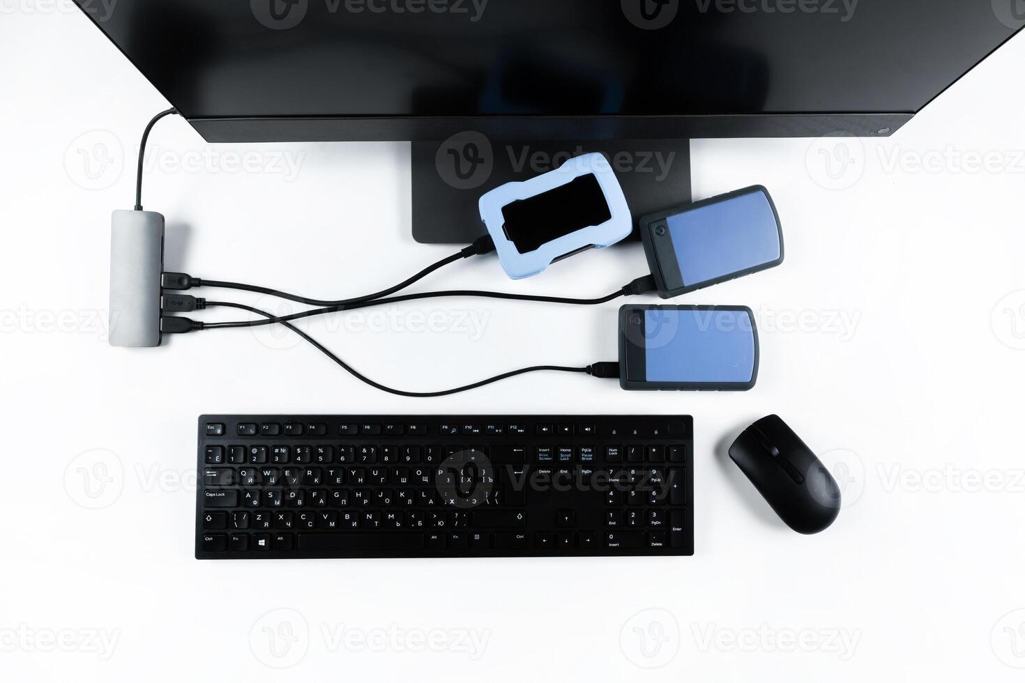 Multiple external hard drives connected to a monoblock on a white background.Computer with hard drive photo