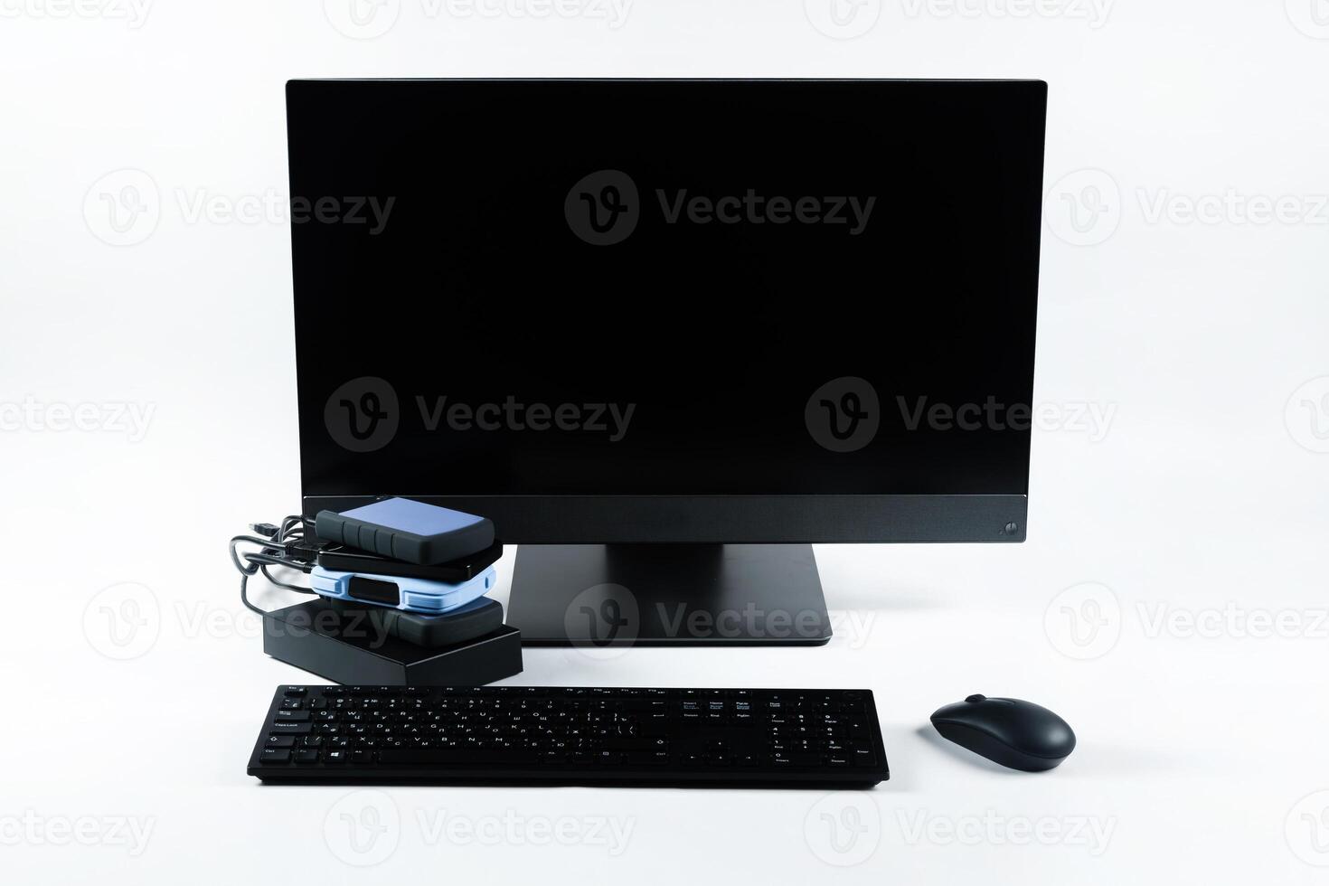 Multiple external hard drives connected to a monoblock on a white background.Computer with hard drive photo