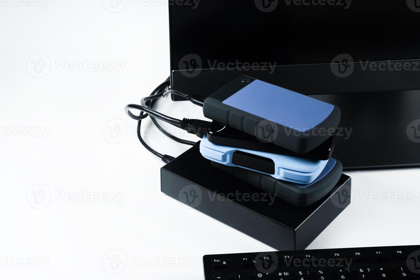 Multiple external hard drives connected to a monoblock on a white background.Computer with hard drive photo