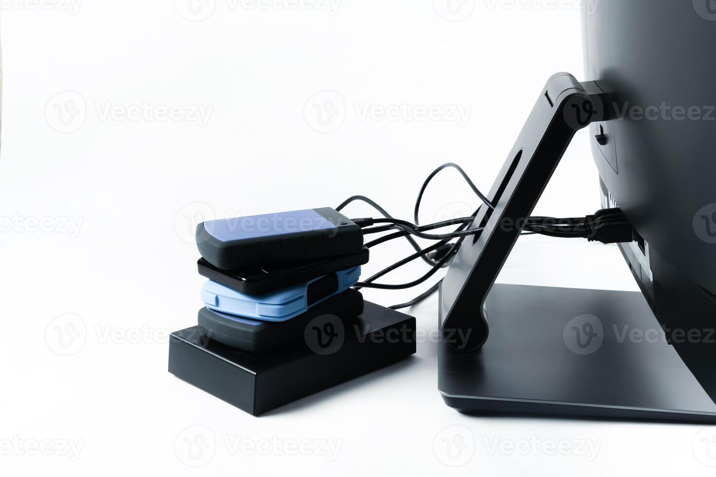 Multiple external hard drives connected to a monoblock on a white background.Computer with hard drive photo