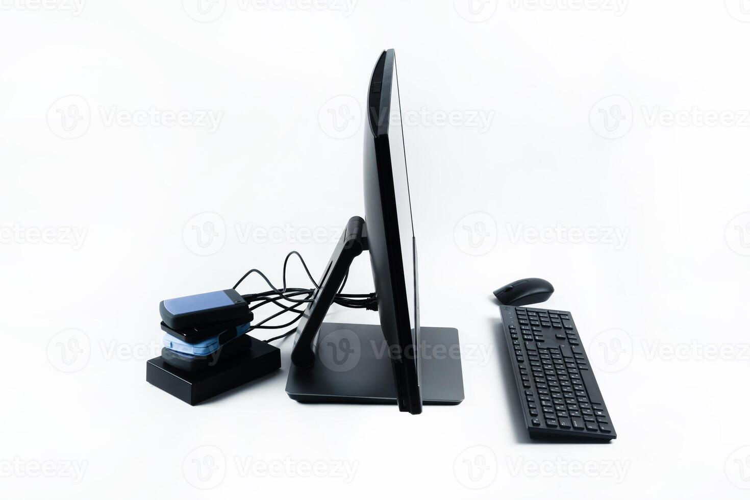 Multiple external hard drives connected to a monoblock on a white background.Computer with hard drive photo