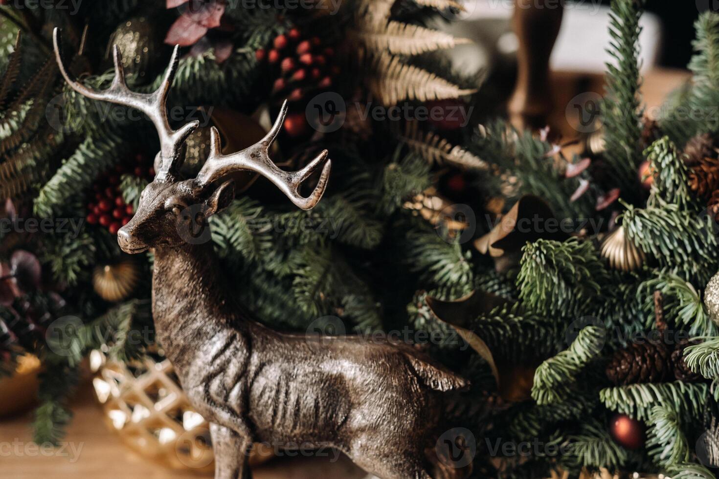 Christmas table decoration, Banquet table with glasses before serving food, Close-up of Christmas dinner table with seasonal decorations, crystal glasses and decorative deer photo