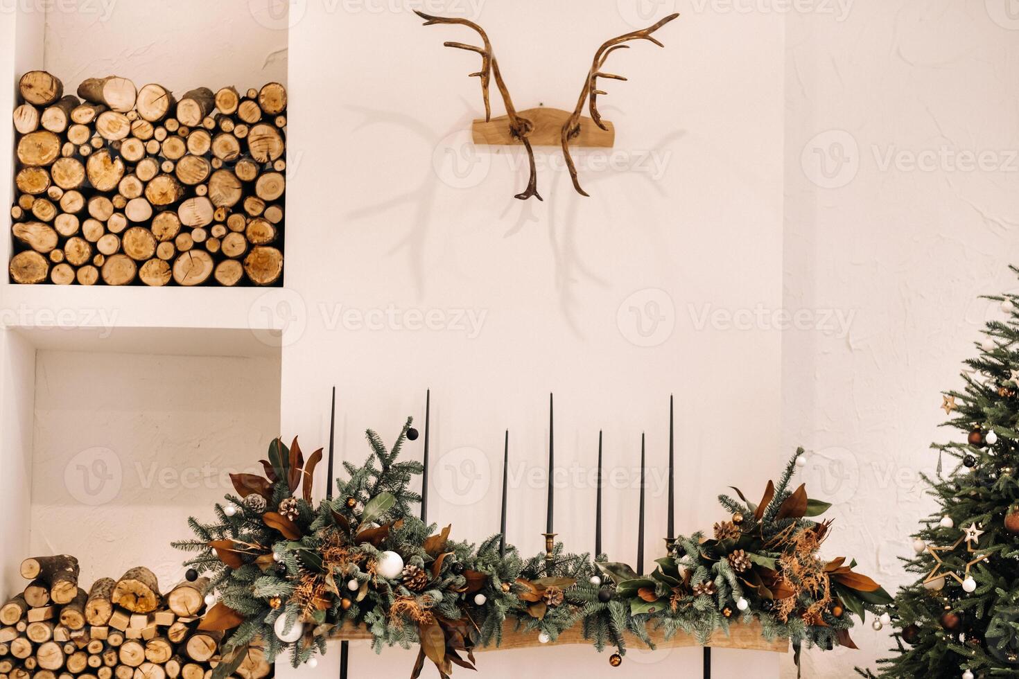Christmas tree in the home Christmas interior near the fireplace with wood.Decorated Christmas photo zone