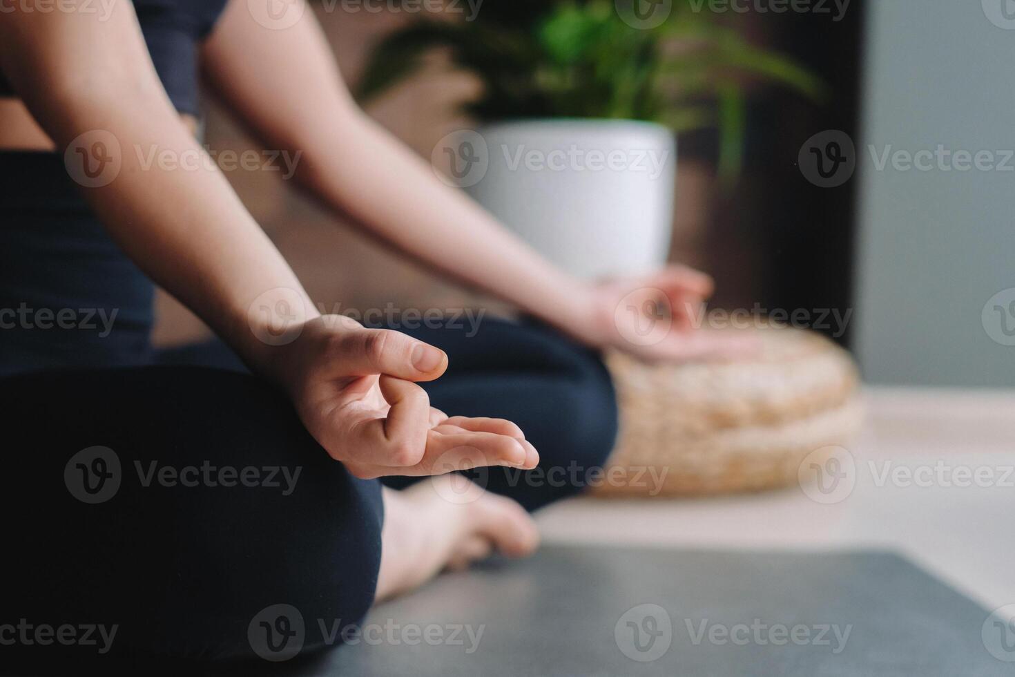 Close-up of a young woman in black clothes doing yoga in a modern gym.The concept of health photo