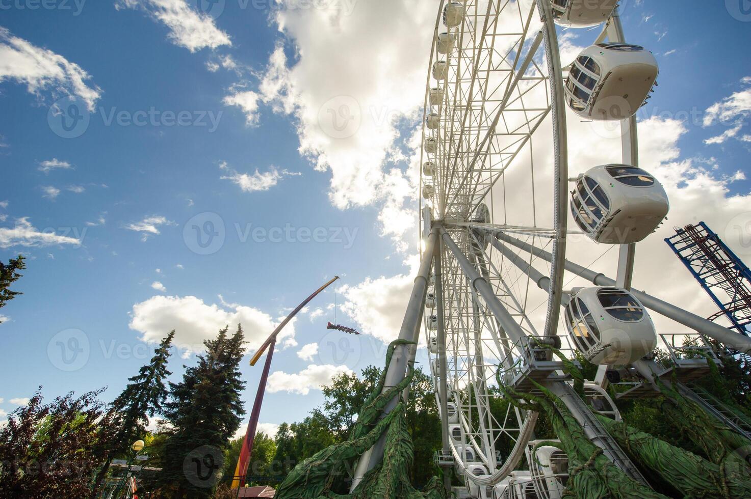 Large Ferris wheel on a blue sky background, close-up. The city of St. Petersburg amusement Park photo