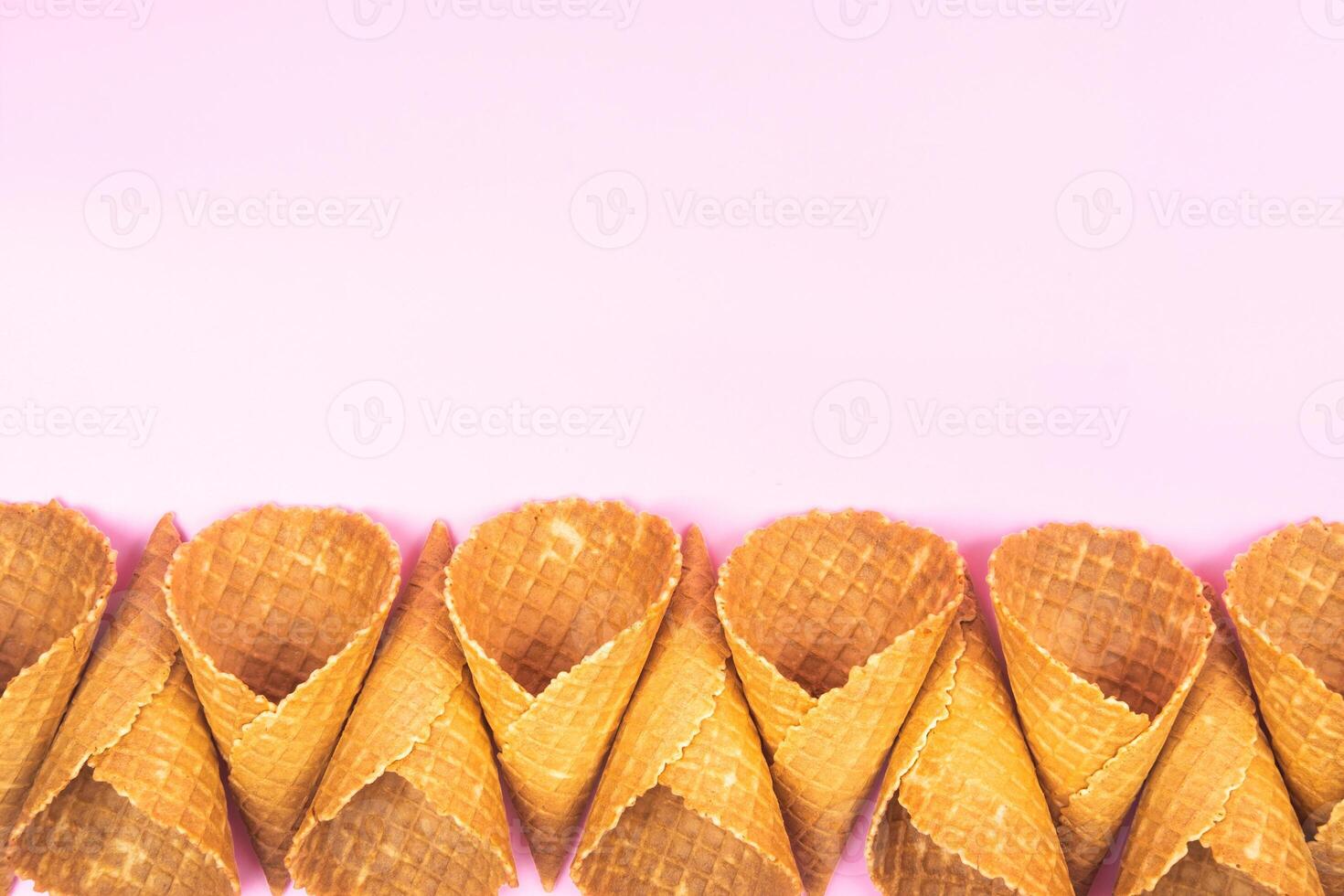 Empty waffle cones for ice cream on a pink background photo