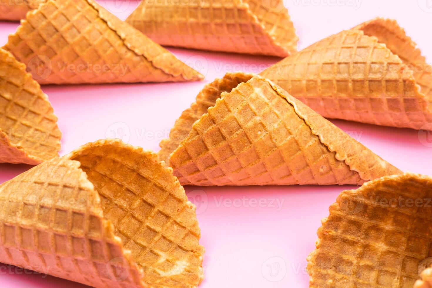 Waffle empty ice cream cones on a colored pink background photo