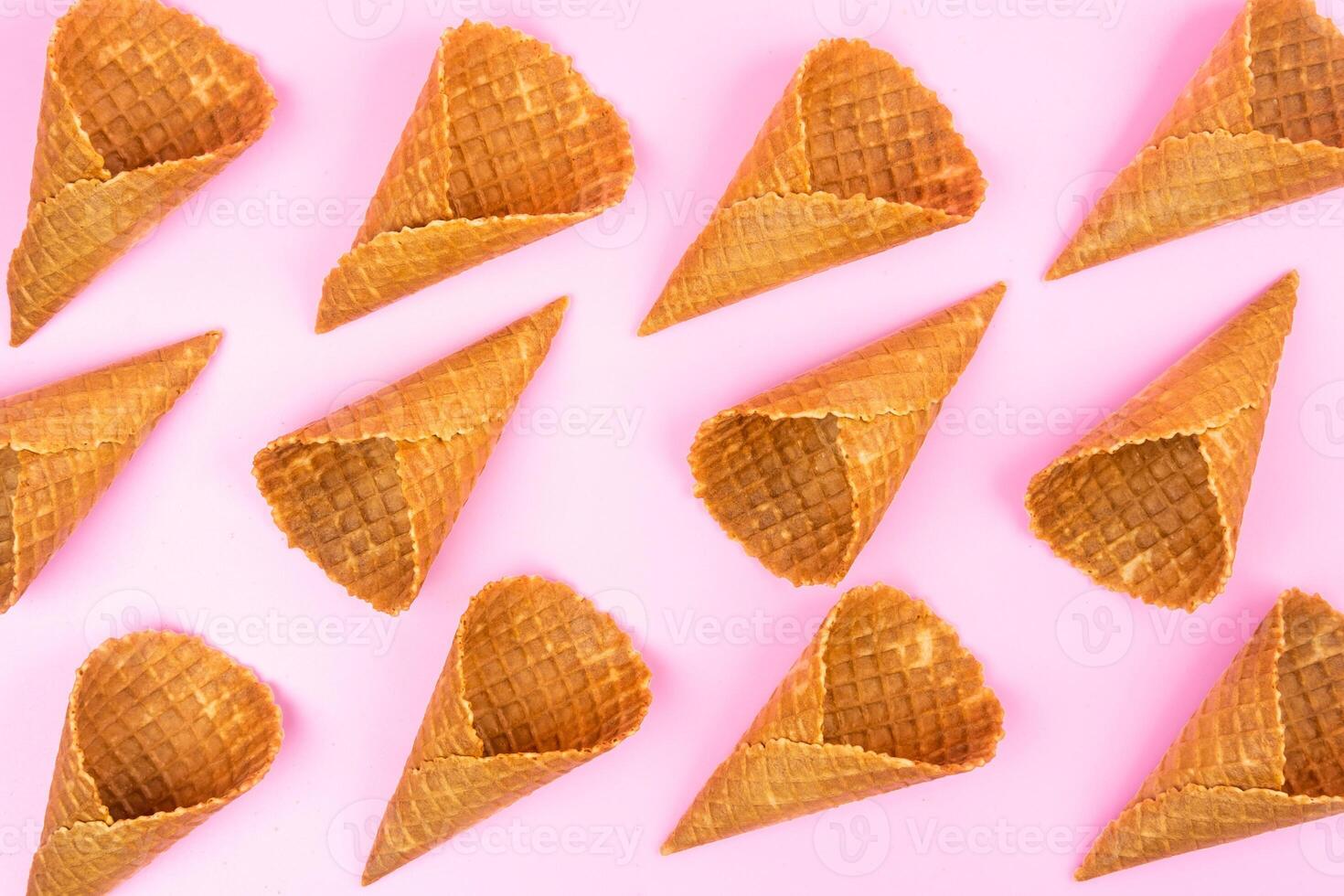 Waffle empty ice cream cones on a colored pink background photo