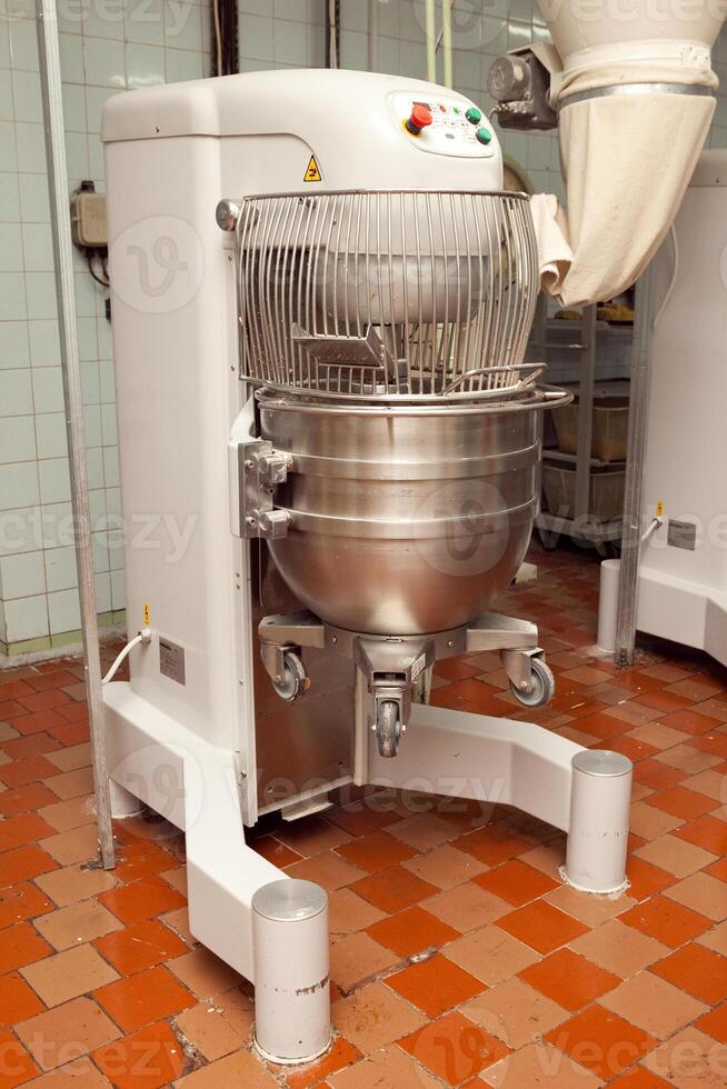 The process of making cookie dough in an industrial kneading machine at the factory photo