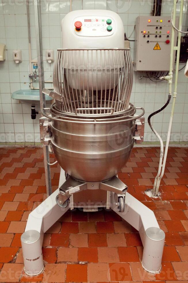 The process of making cookie dough in an industrial kneading machine at the factory photo
