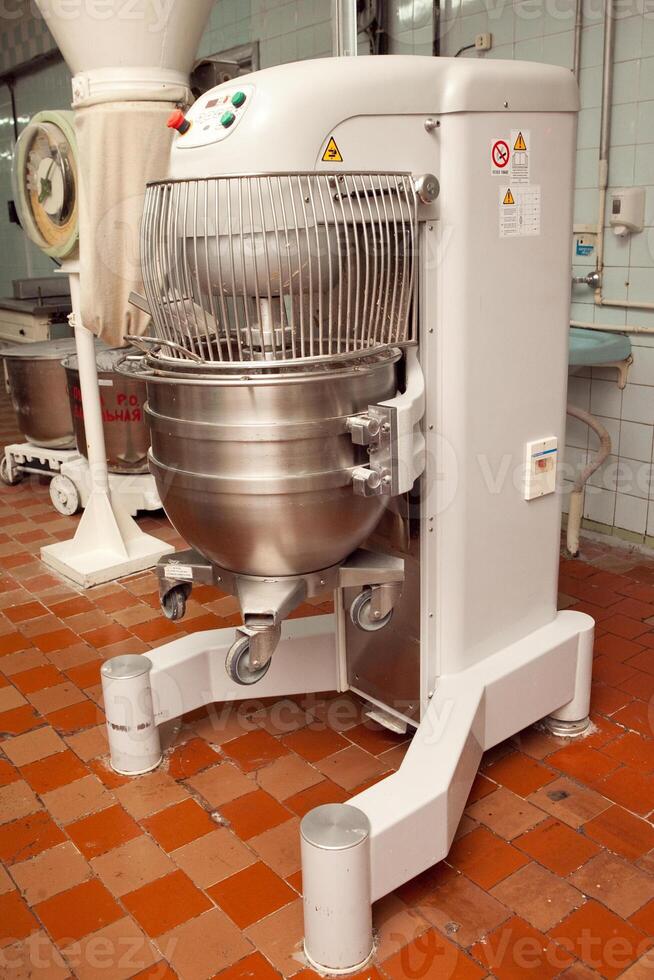 The process of making cookie dough in an industrial kneading machine at the factory photo