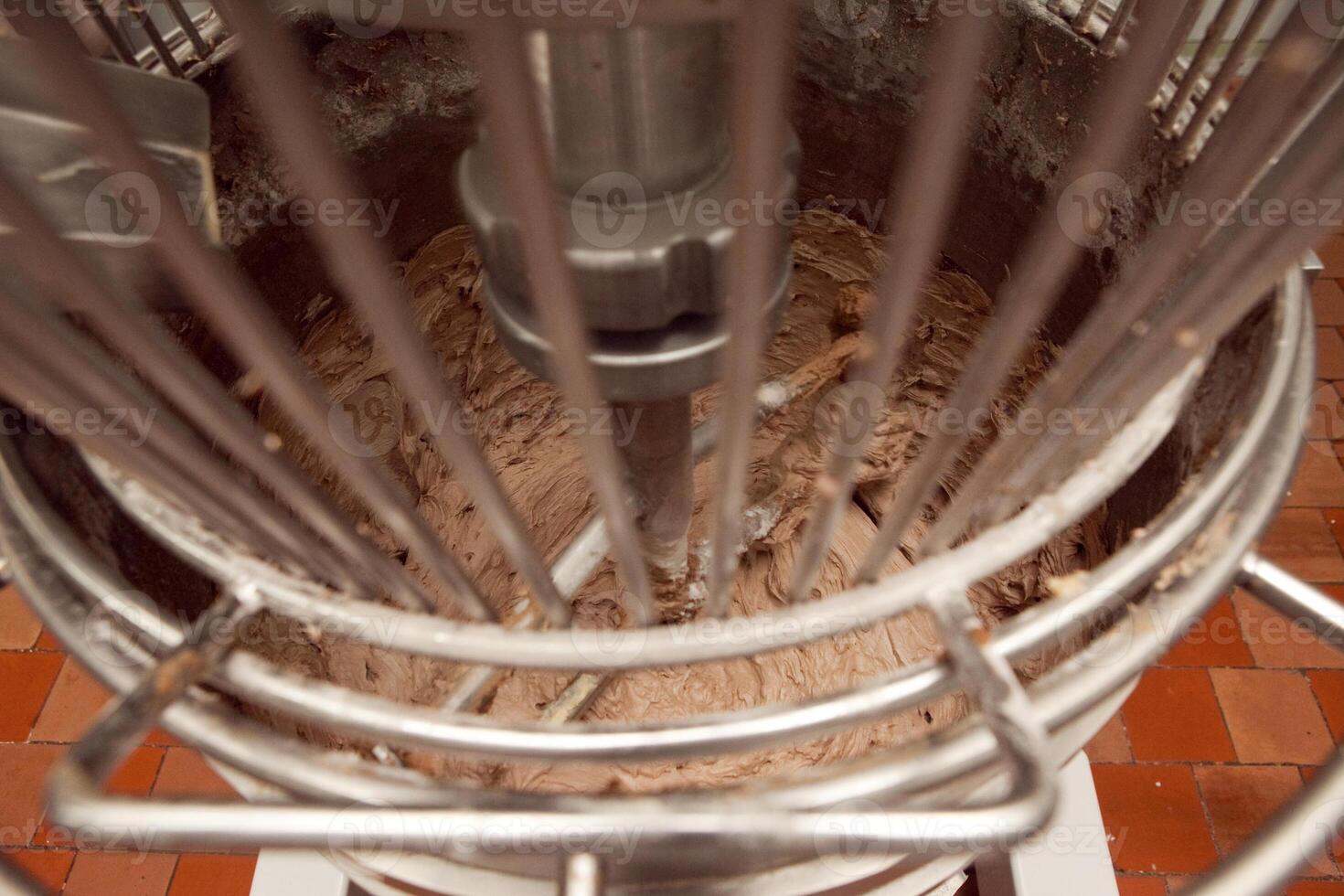 The process of making cookie dough in an industrial kneading machine at the factory photo