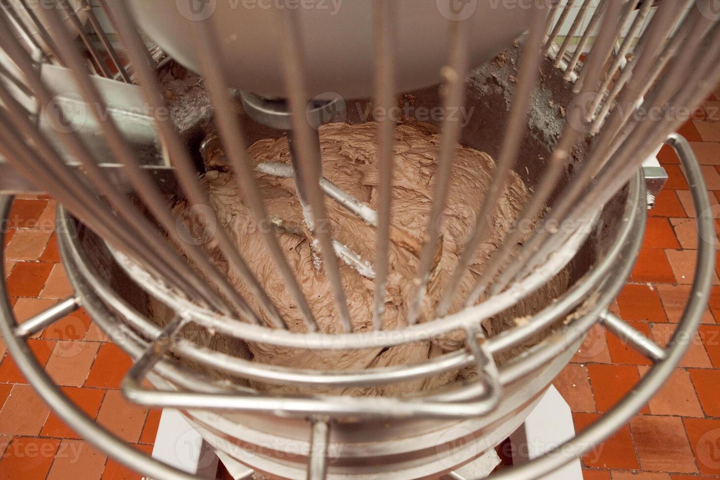 The process of making cookie dough in an industrial kneading machine at the factory photo
