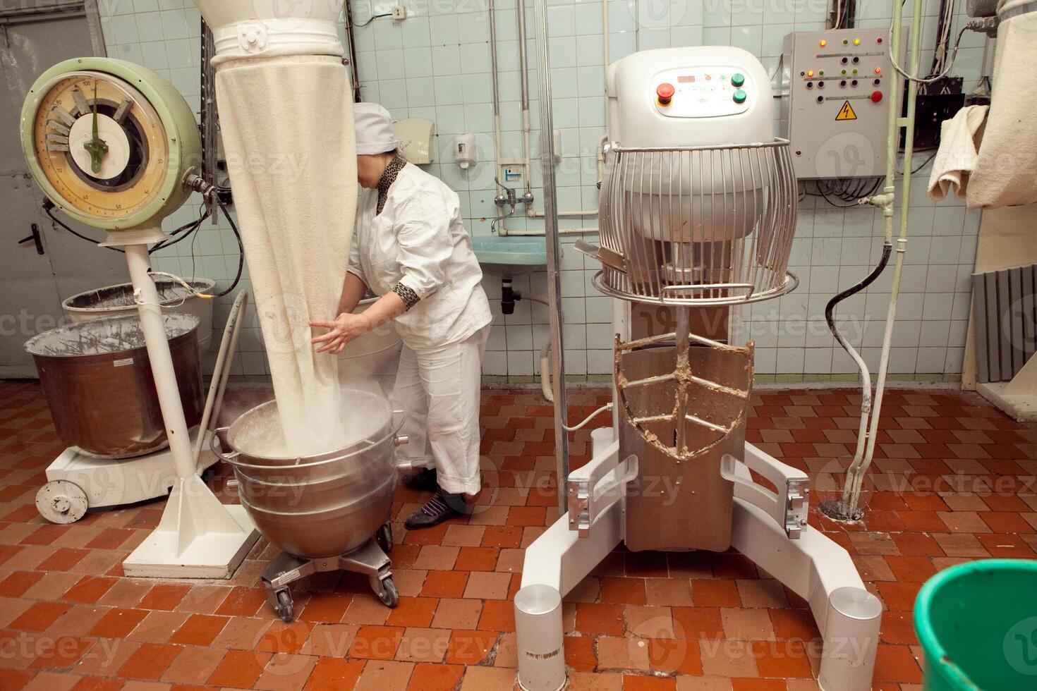 The process of making cookie dough in an industrial kneading machine at the factory photo
