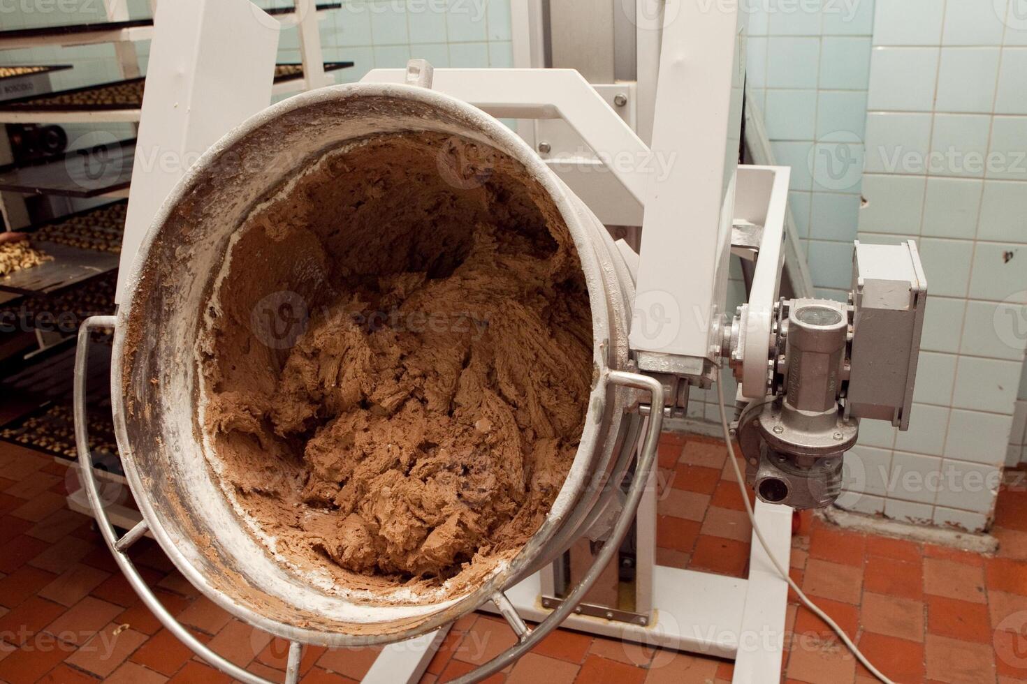 The process of making cookie dough in an industrial kneading machine at the factory photo