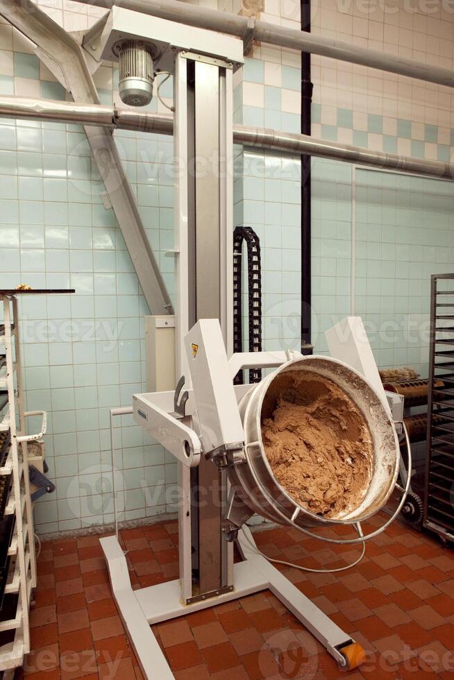 The process of making cookie dough in an industrial kneading machine at the factory photo
