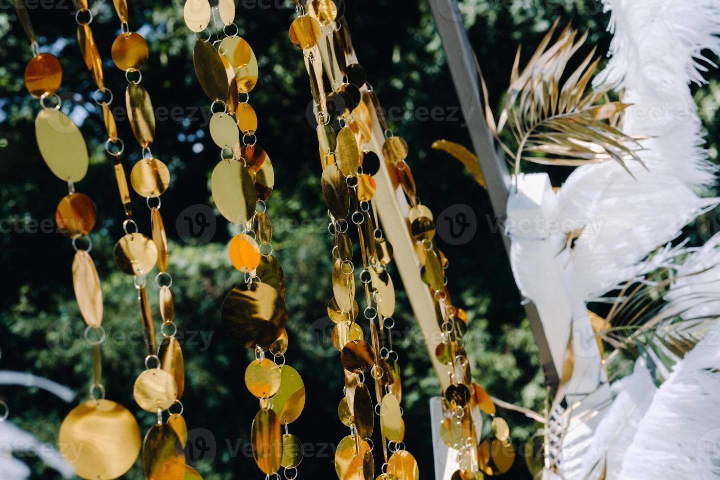 Decorated wedding arch in nature.Wedding ceremony with an arch decorated with feathers in retro style photo