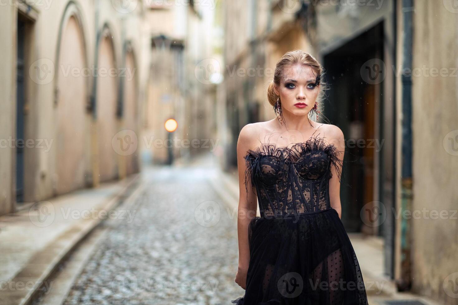 A stylish bride in a black wedding dress in the ancient French city of Avignon. A model in a black dress photo
