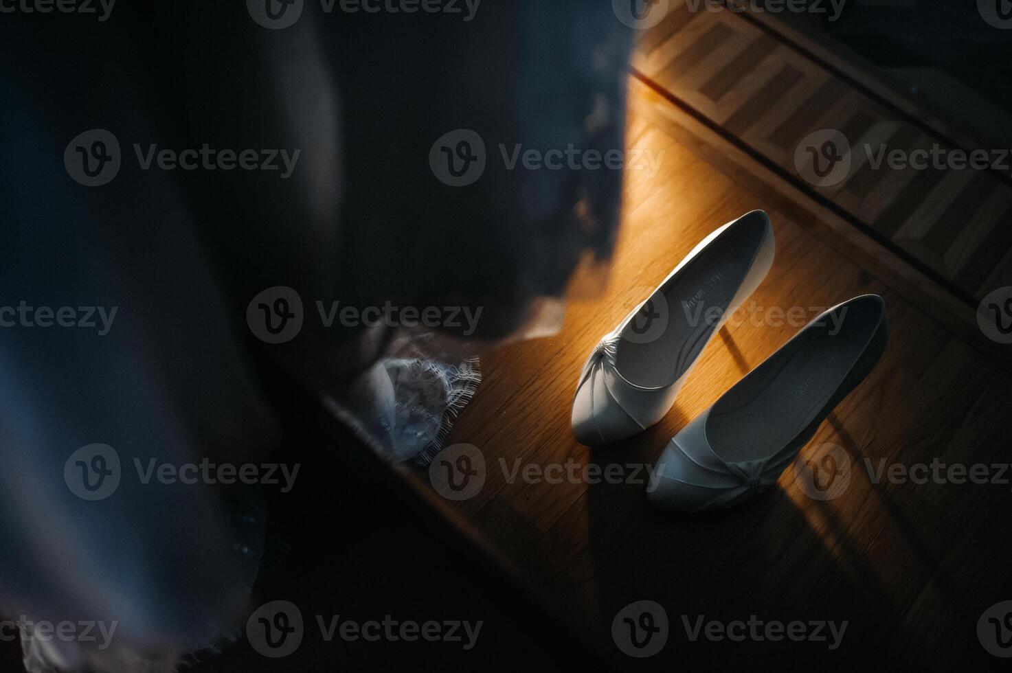 white wedding shoes standing on the field near the dress photo