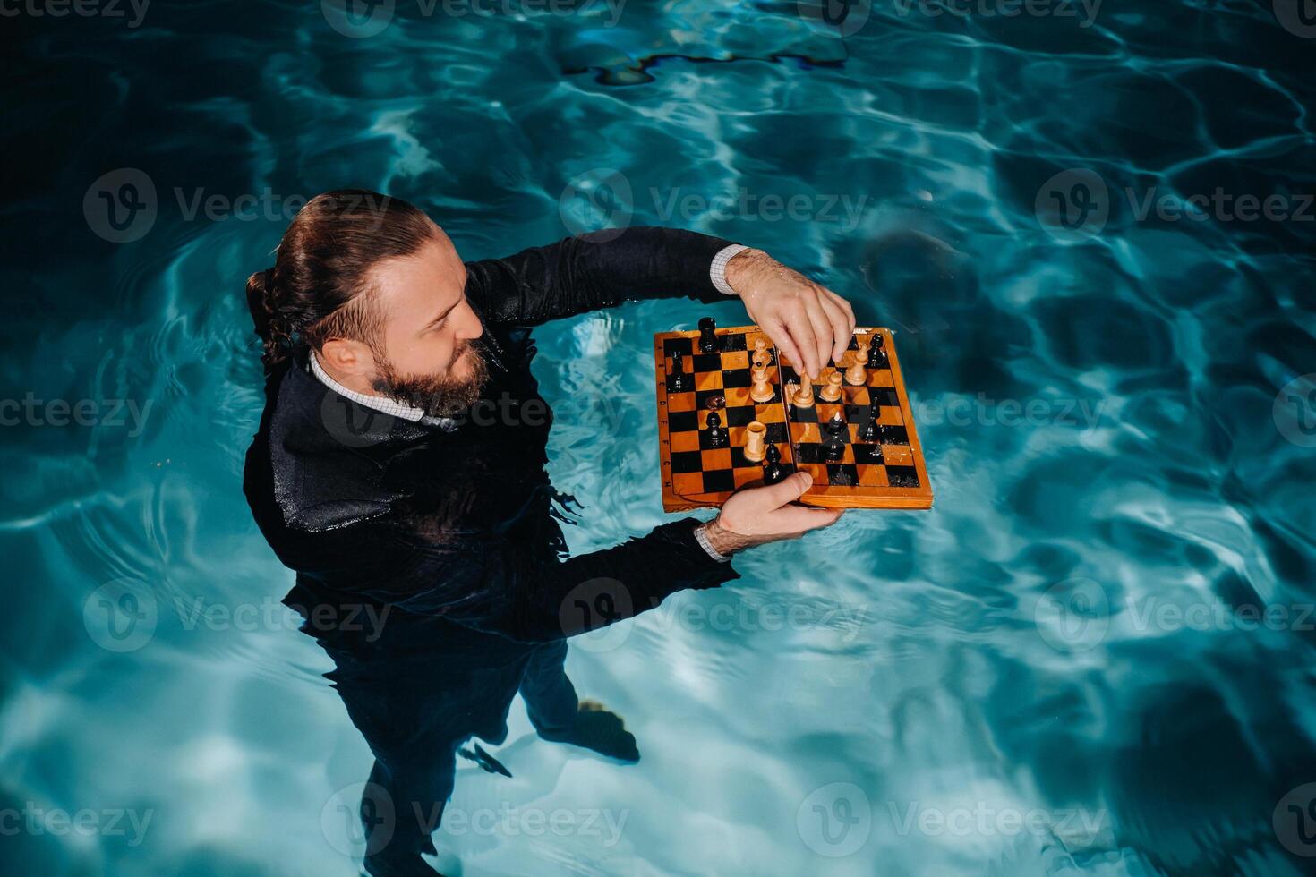 a man in a suit plays chess on the water in the pool photo