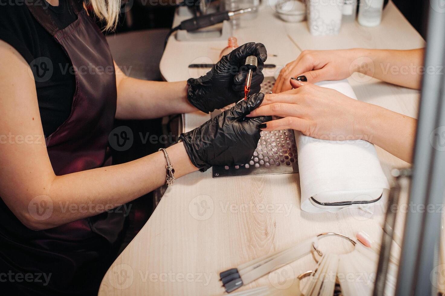 Beautician Salon, Manicure, Nails Polish Procedure. Professional hardware manicure using electric machine in beauty salon. master uses an electric machine to remove nail polish hands during manicure. photo