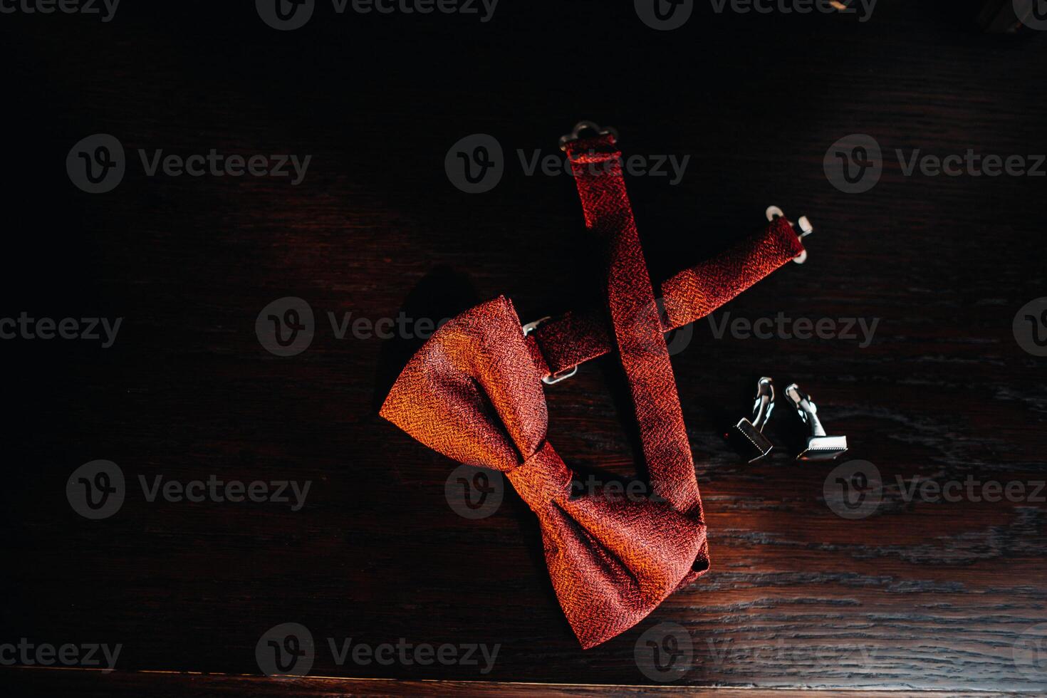 Red bow Tie on a dark background and cufflinks.wedding concept photo