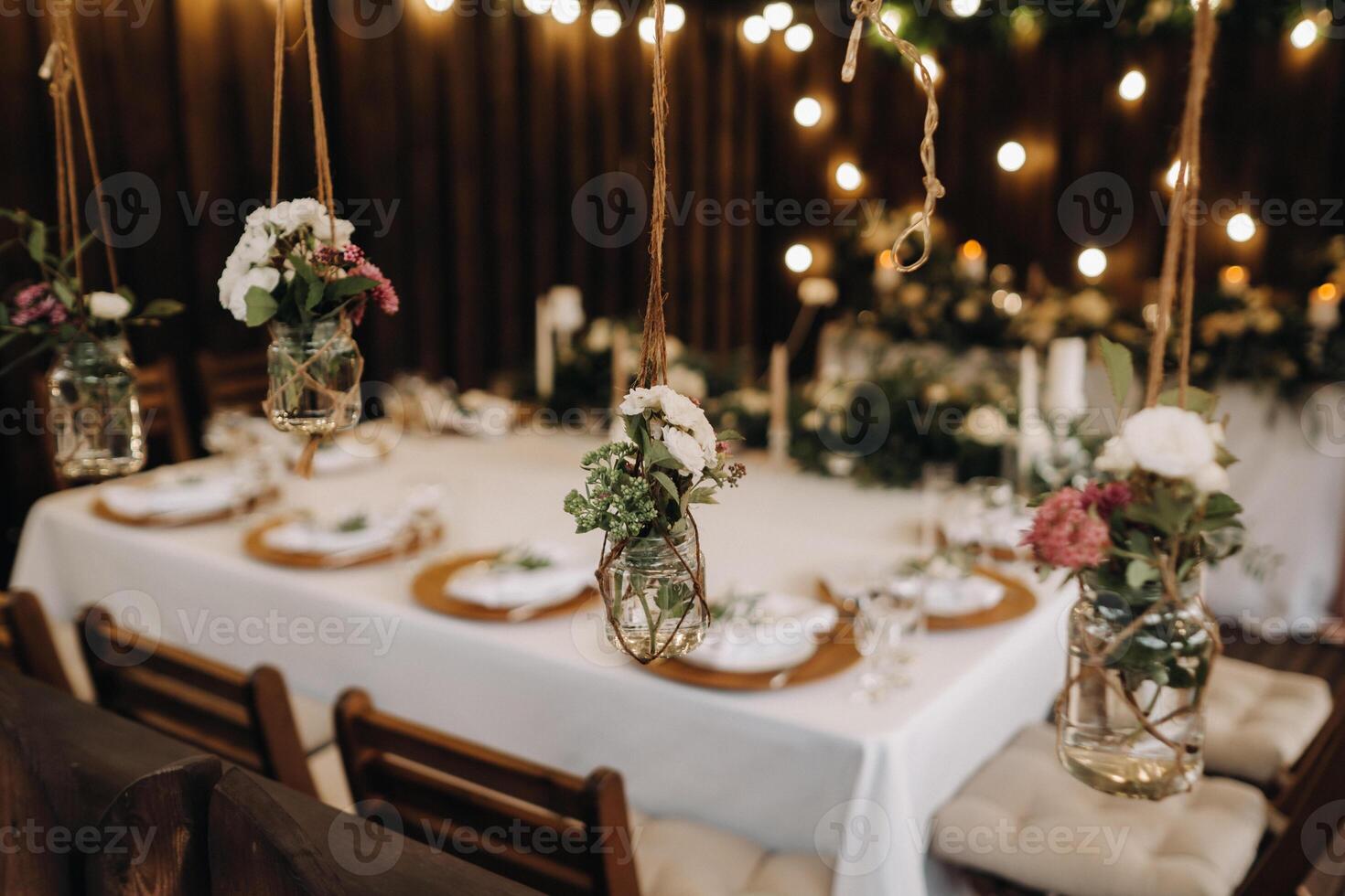 wedding table decoration with flowers on the table in the castle, table decor for dinner by candlelight.Dinner with candles photo