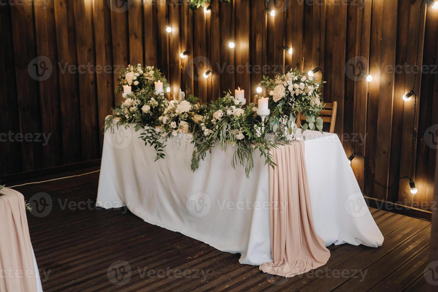 wedding table decoration with flowers on the table in the castle, table decor for dinner by candlelight.Dinner with candles photo