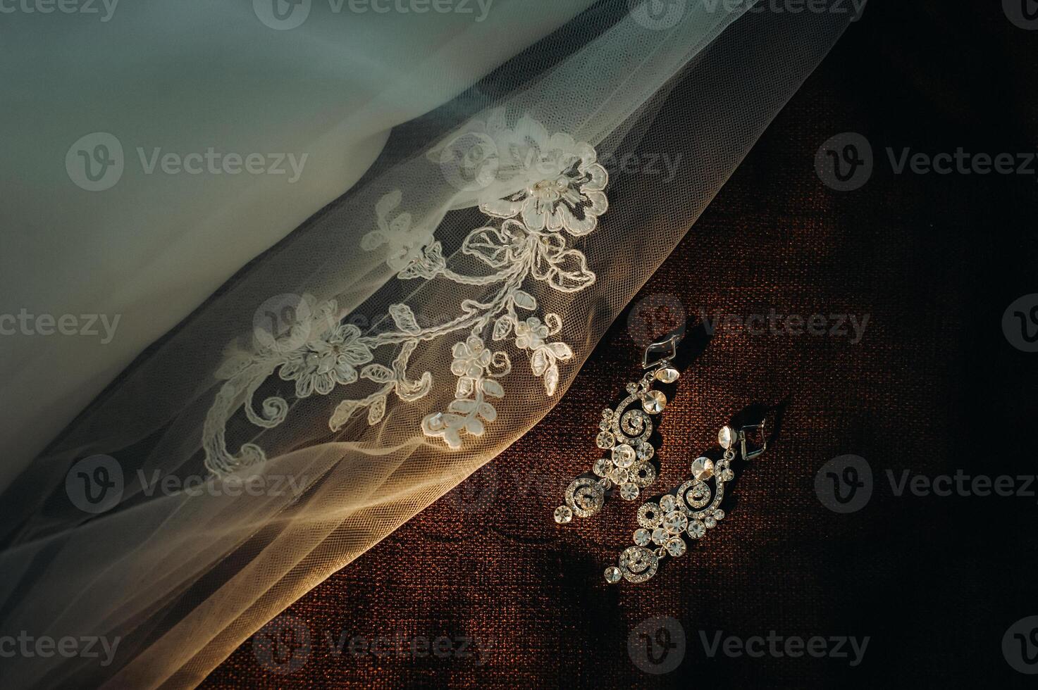 Accessories for the bride. Earrings on the veil. White wedding earrings. Space for text and ads. photo