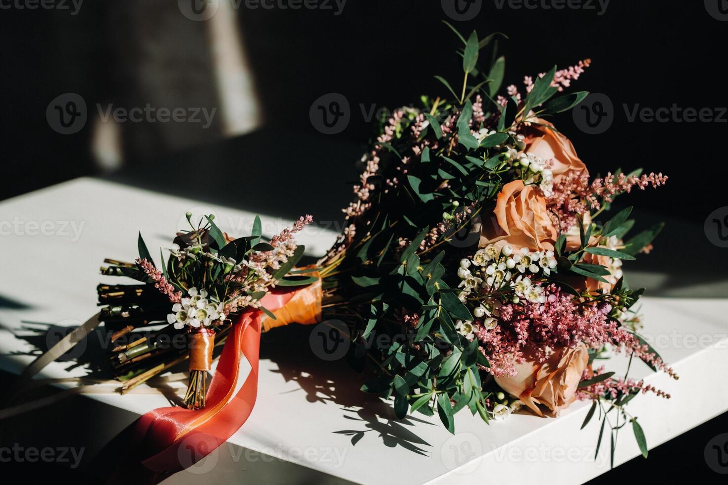 wedding bouquet with roses on the table and a boutonniere.The decor at the wedding photo