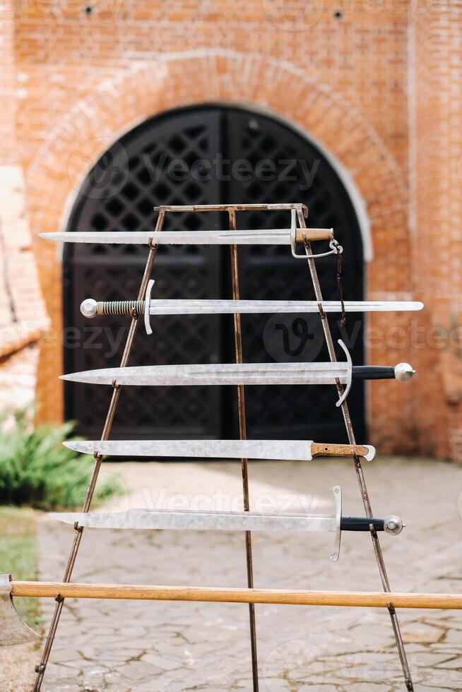 Ancient swords against the background of the castle in Nesvizh.Nesvizh castle, Medieval swords photo