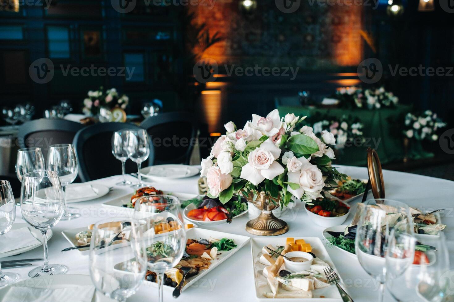 wedding table decoration with flowers on the table in the castle, table decor for dinner by candlelight.Dinner with candles photo
