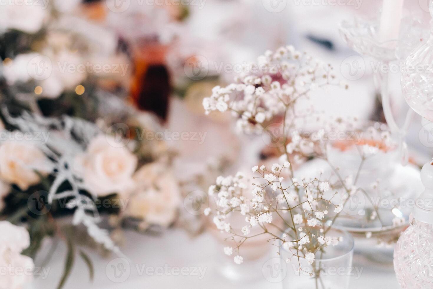 decoration with fluffy flowers on the table in winter style at the wedding photo