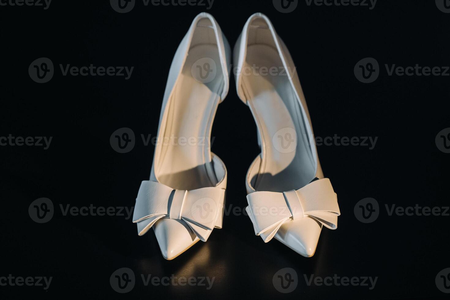 white wedding shoes on a black background photo