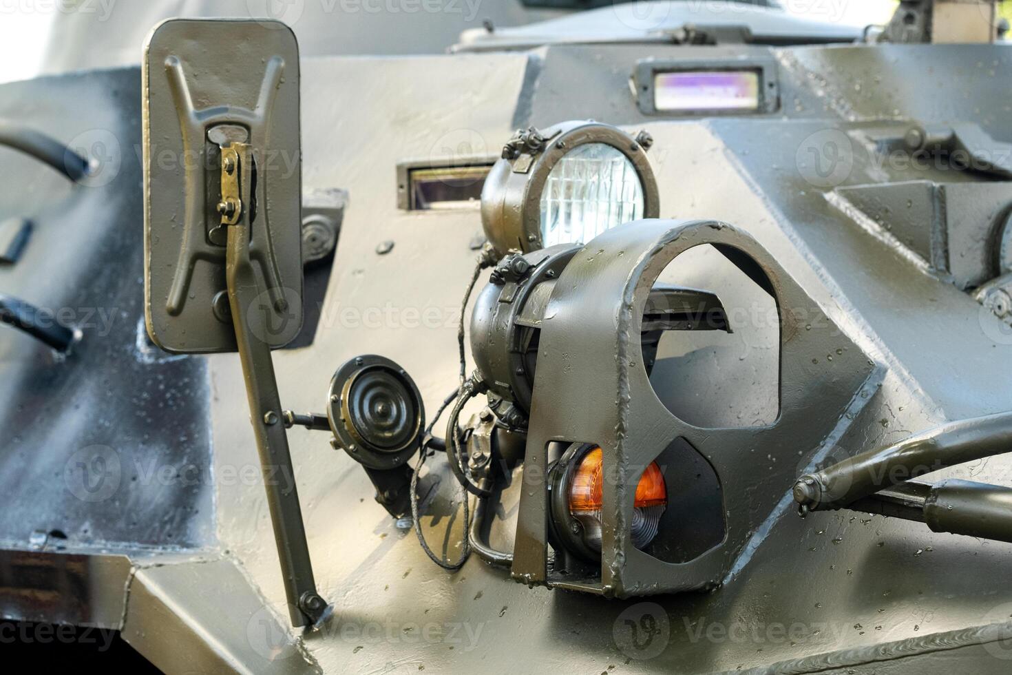 Headlights of an armored combat vehicle. Close-up of combat military equipment with light lights photo