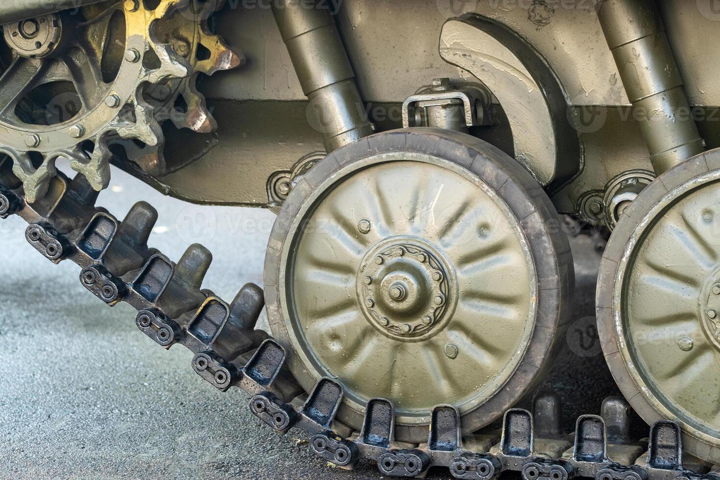 Tracked armor close-up. Black link tracks and large rubberized rollers. Chassis of an infantry fighting vehicle photo