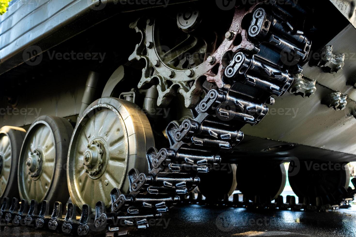 Tracked armor close-up. Black link tracks and large rubberized rollers. Chassis of an infantry fighting vehicle photo